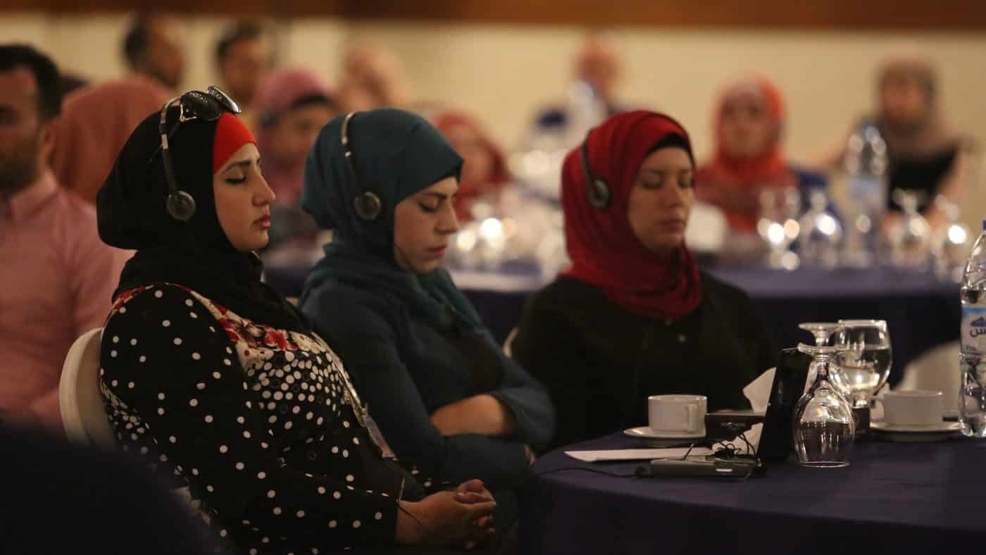Syrian women meditating during mind-body skills training