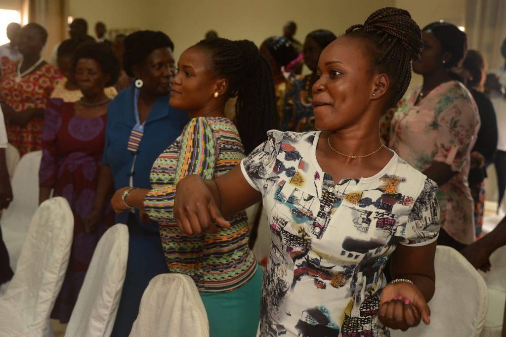 Women shaking and dancing to release stress.