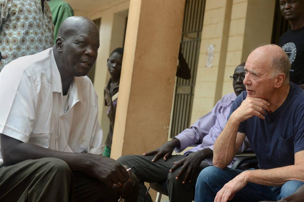 James Gordon, MD listening to the concerns of Brigadier General James Madol Mac, the director of Defense Health Services
