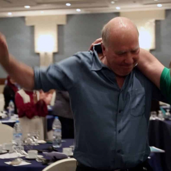James Gordon, MD dancing with Syrian refugee leaders and care-givers during mind-body training