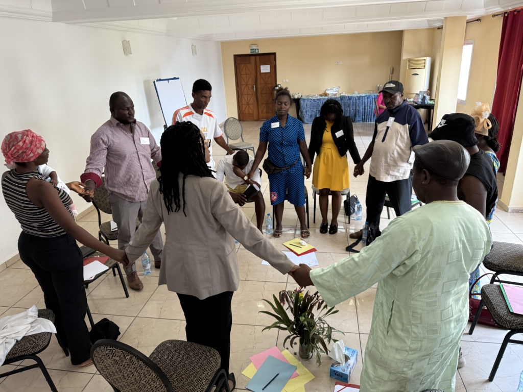 people standing in a circle with hands joined